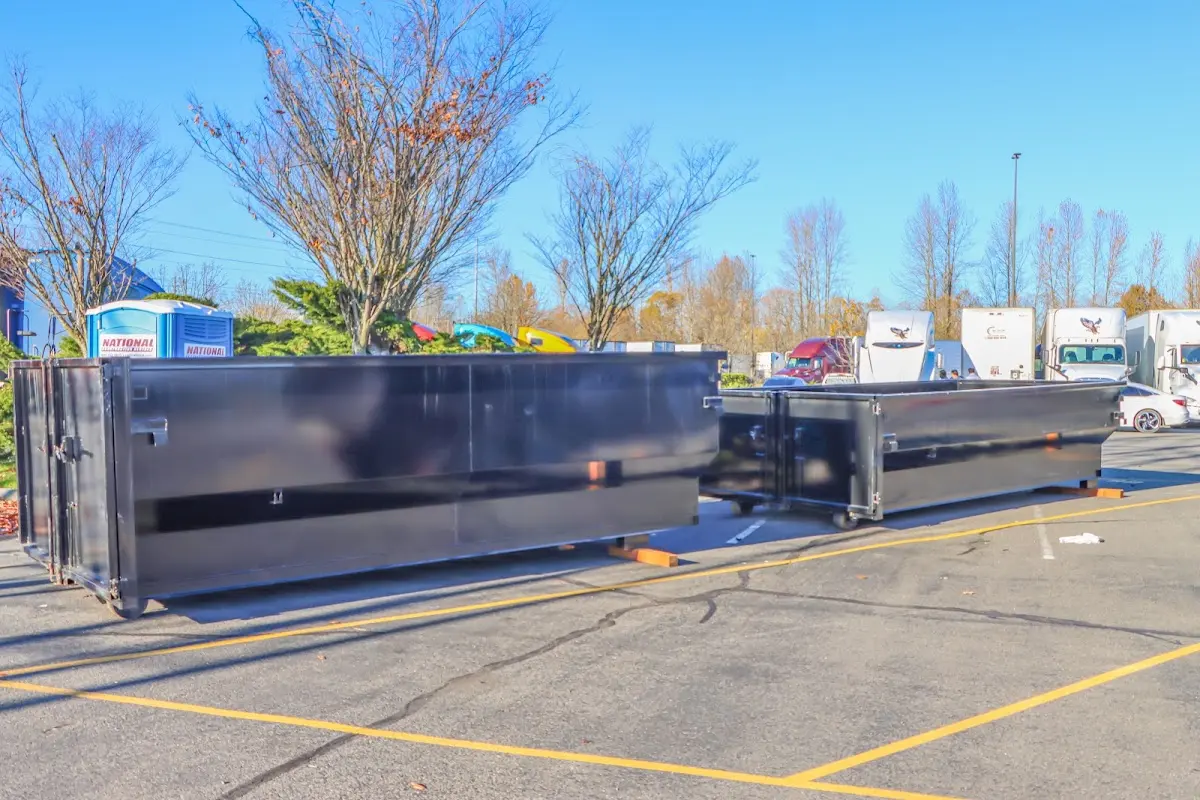 Professional dumpster rental service with roll-off container on residential driveway in Windsor Locks